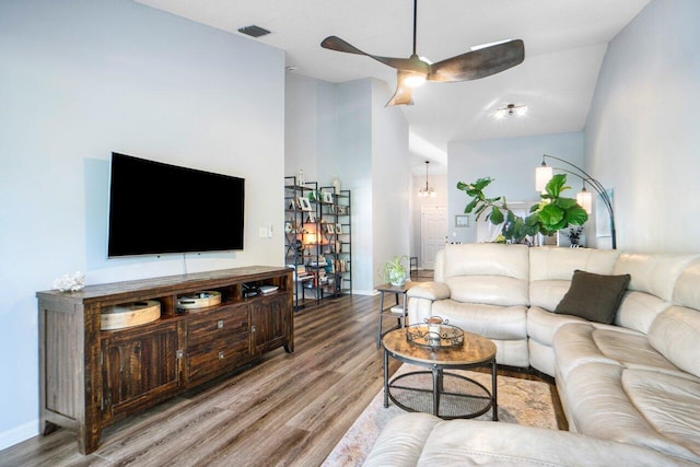 living room with hardwood / wood-style flooring, high vaulted ceiling, and ceiling fan