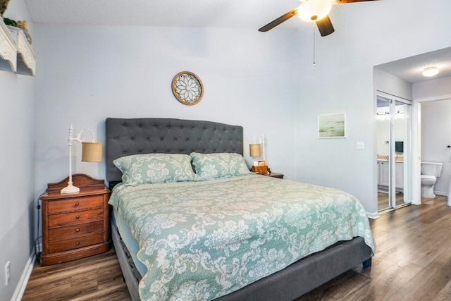 bedroom with dark wood-type flooring, ceiling fan, ensuite bathroom, a textured ceiling, and a closet