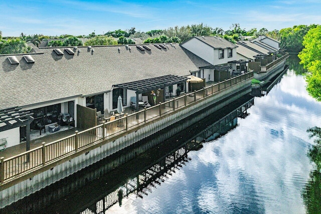 rear view of property with a water view