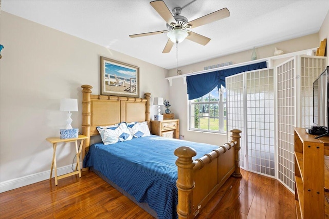 bedroom featuring dark hardwood / wood-style flooring and ceiling fan