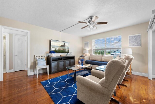 living room with wood-type flooring and ceiling fan