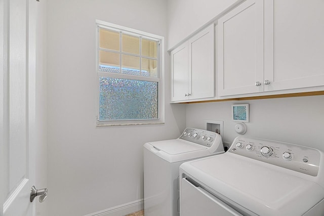 washroom featuring cabinets and independent washer and dryer