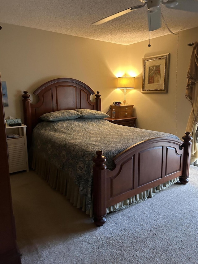 carpeted bedroom with a textured ceiling and ceiling fan