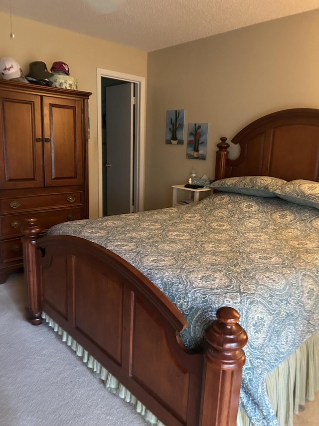 carpeted bedroom with a textured ceiling