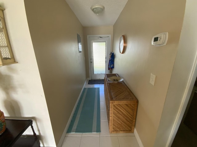 interior space featuring a textured ceiling and light tile patterned floors