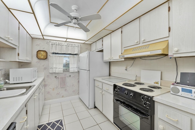 kitchen featuring sink, white cabinets, light tile patterned floors, ceiling fan, and white appliances