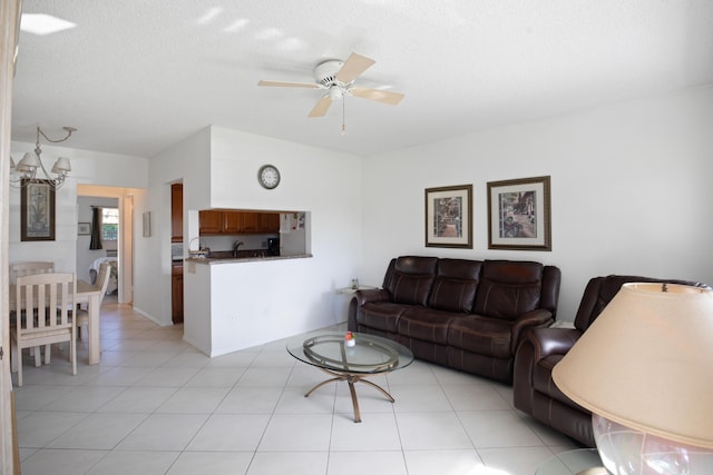 living room featuring light tile patterned floors, a textured ceiling, and ceiling fan