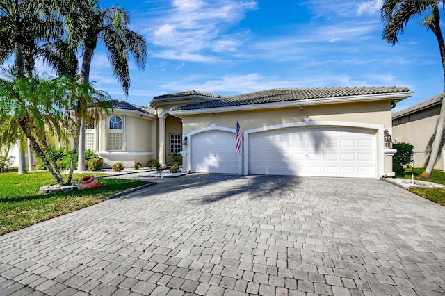 mediterranean / spanish home featuring a garage