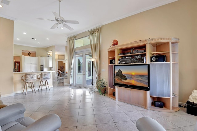 living room featuring ornamental molding, light tile patterned floors, and ceiling fan