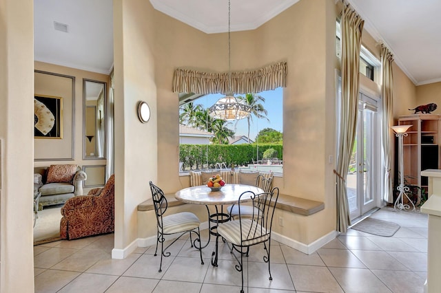 dining area featuring ornamental molding, a wealth of natural light, and light tile patterned flooring