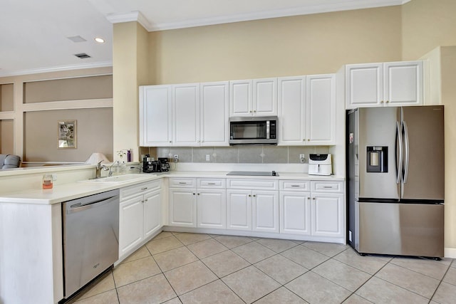 kitchen with light tile patterned flooring, sink, crown molding, appliances with stainless steel finishes, and white cabinets