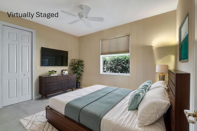 bedroom with light colored carpet, a closet, and ceiling fan