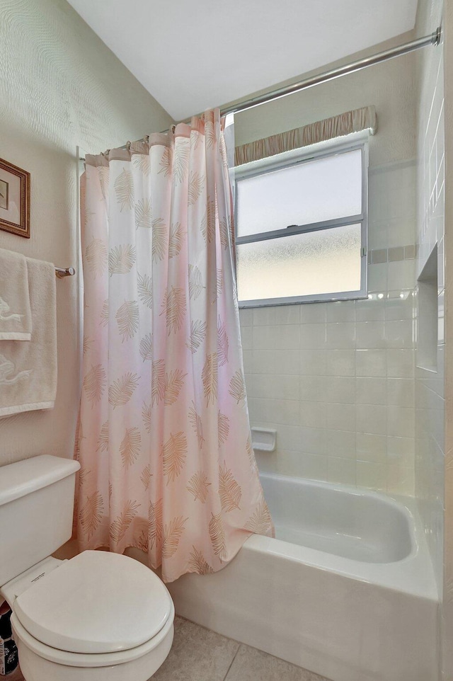 bathroom featuring shower / tub combo with curtain, toilet, and tile patterned flooring