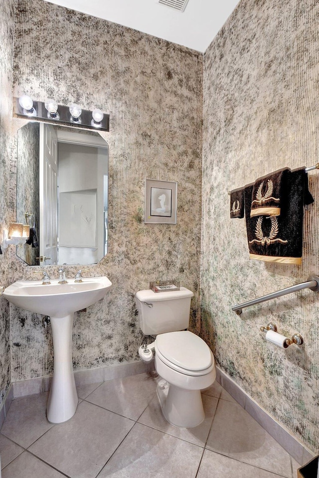 bathroom featuring tile patterned flooring, sink, and toilet