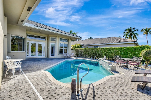 view of pool featuring a patio and french doors