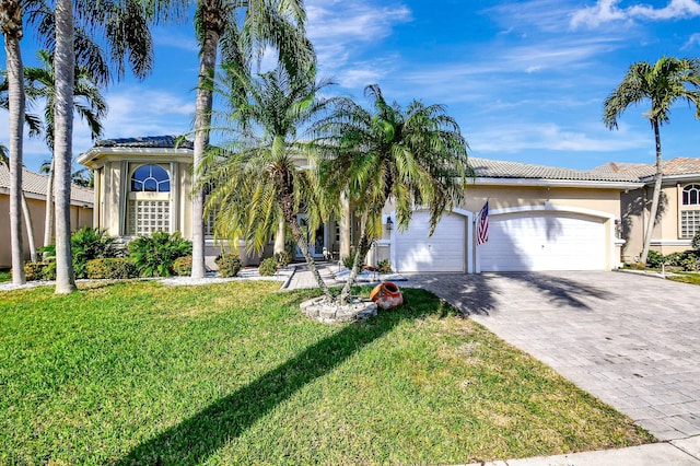 view of front facade with a garage and a front yard