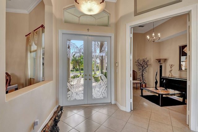 foyer entrance featuring french doors, ornamental molding, a chandelier, and light tile patterned floors