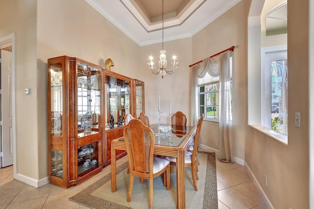 dining space featuring an inviting chandelier, a tray ceiling, crown molding, and light tile patterned flooring