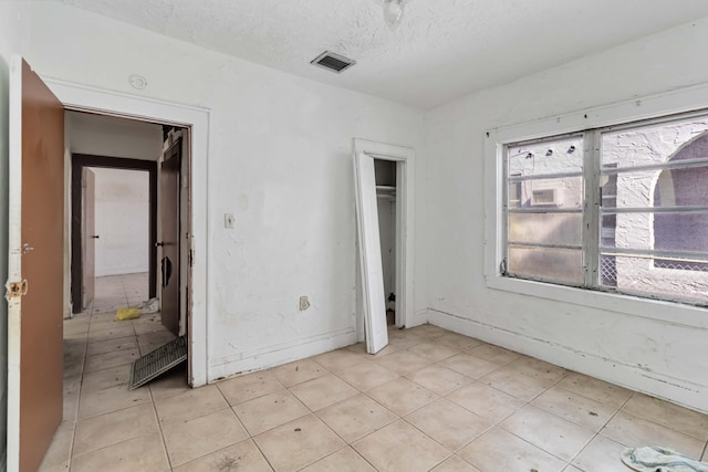 1839 NW 49th St, Miami, FL 33142 - unfurnished bedroom featuring a textured ceiling and a closet