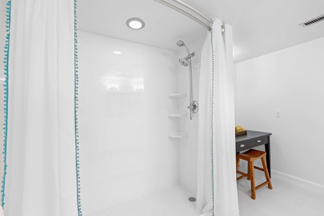 bathroom with tile patterned flooring and a shower with shower curtain