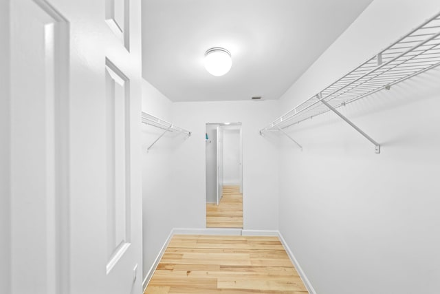 walk in closet featuring hardwood / wood-style flooring