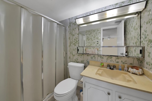 bathroom with vanity, an enclosed shower, and toilet