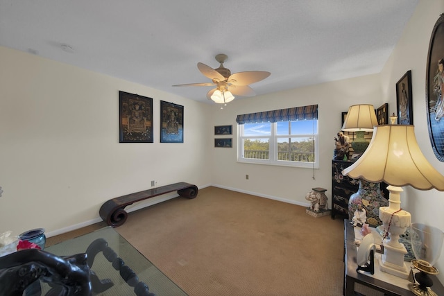 exercise room with ceiling fan and carpet floors
