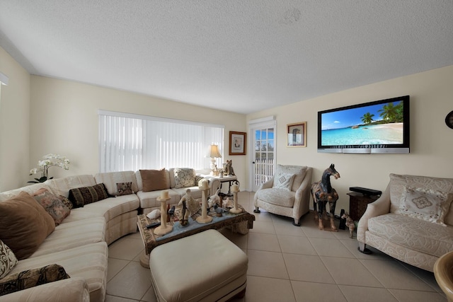living room with a textured ceiling and light tile patterned flooring