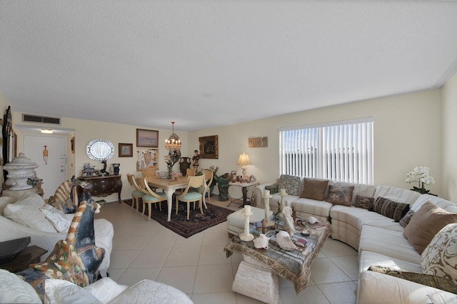 living room with a textured ceiling and light tile patterned floors