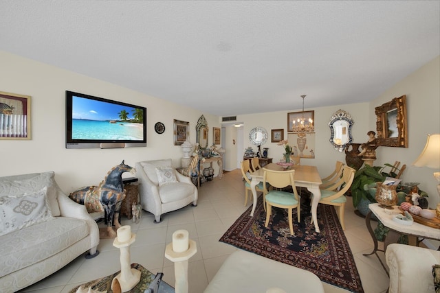 living room with a chandelier, a textured ceiling, and light tile patterned floors
