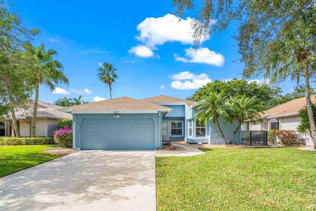 ranch-style house featuring a garage and a front yard