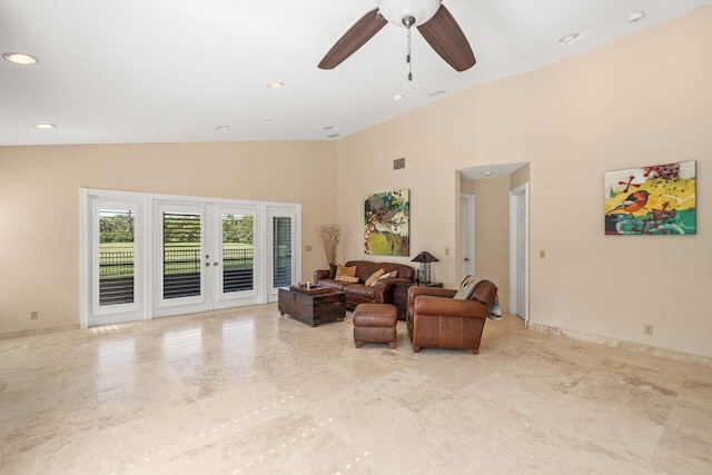 living room with a high ceiling, ceiling fan, and french doors