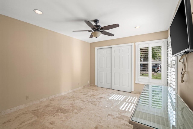 unfurnished bedroom with multiple windows, ceiling fan, and a closet