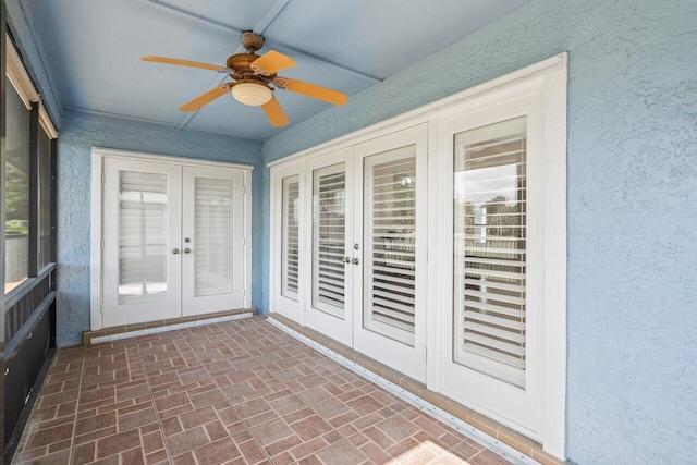 unfurnished sunroom with ceiling fan and french doors