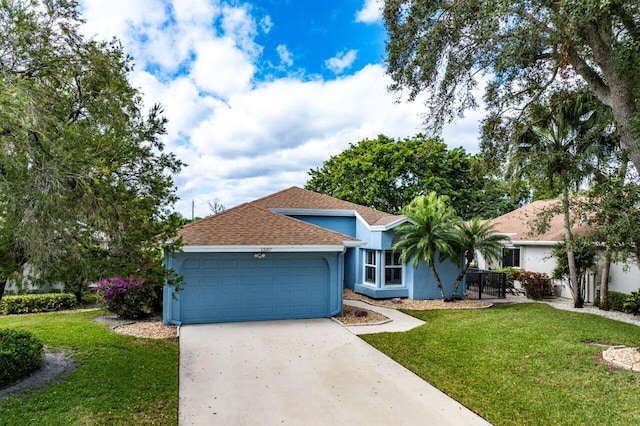 ranch-style home featuring a garage and a front yard