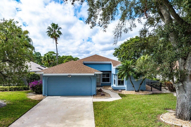 view of front of property featuring a garage and a front yard