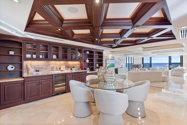 interior space featuring coffered ceiling, beverage cooler, and beam ceiling