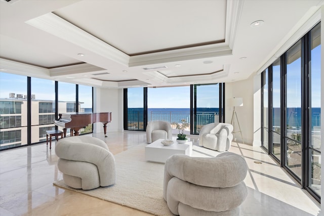 living room featuring ornamental molding, expansive windows, and a water view