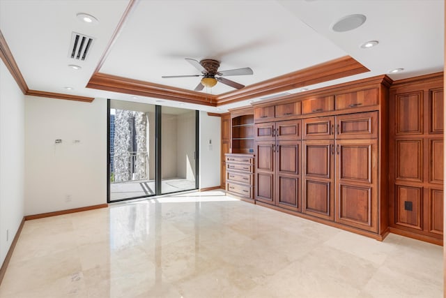 interior space featuring ornamental molding, a tray ceiling, and access to outside