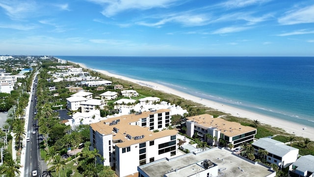 aerial view with a water view and a beach view