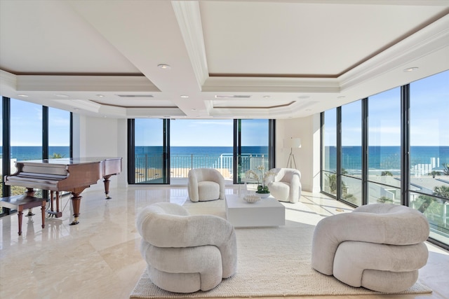 living room featuring expansive windows, crown molding, a water view, and a tray ceiling