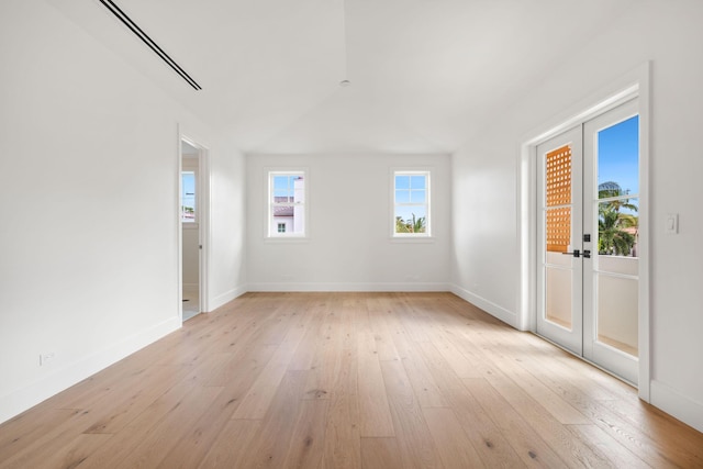 unfurnished living room featuring french doors, light wood-style flooring, and baseboards