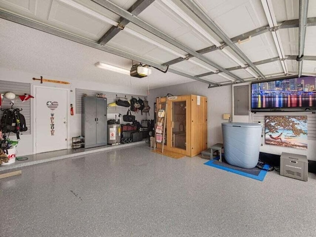 garage featuring a garage door opener and water heater