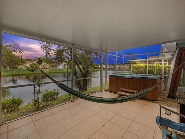 unfurnished sunroom with a water view