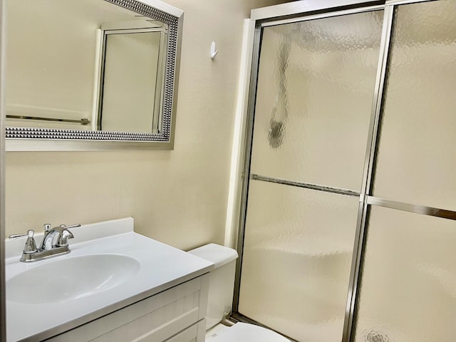 15 Lake Vista Trl Unit 206, Port Saint Lucie, FL 34952 - bathroom featuring a shower with door, toilet, and vanity