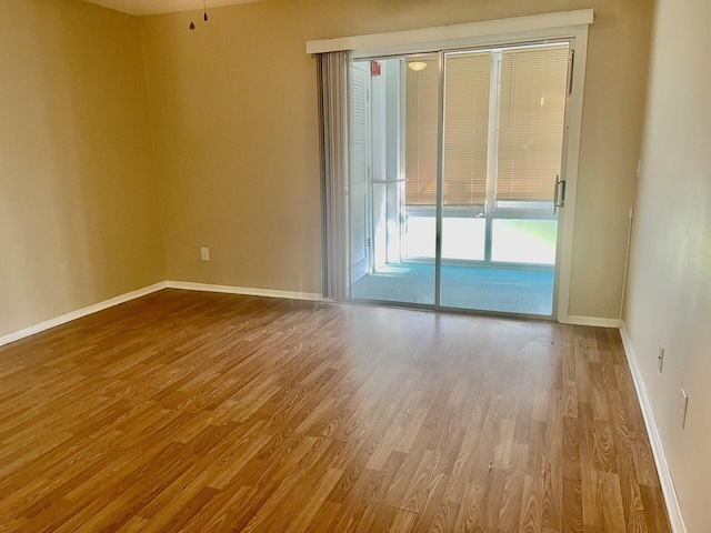 spare room with wood-type flooring