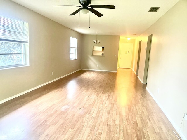 15 Lake Vista Trl Unit 206, Port Saint Lucie, FL 34952 - unfurnished room with a ceiling fan, light wood-style floors, baseboards, and a chandelier