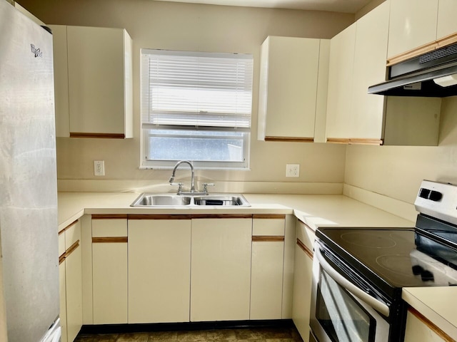 15 Lake Vista Trl Unit 206, Port Saint Lucie, FL 34952 - kitchen featuring stainless steel range with electric stovetop, a sink, under cabinet range hood, and light countertops
