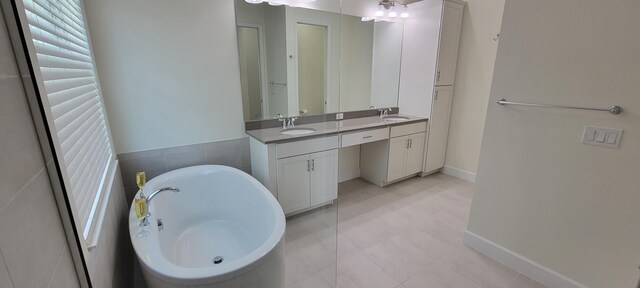 bathroom with vanity, tile patterned flooring, and shower with separate bathtub