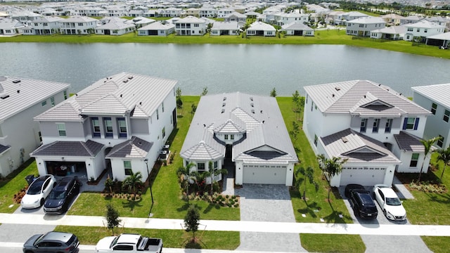 drone / aerial view featuring a residential view and a water view